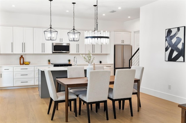 dining space with light hardwood / wood-style floors