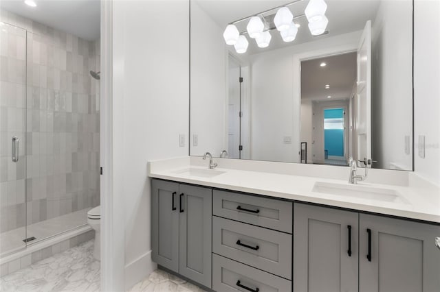 bathroom with vanity, an enclosed shower, and toilet