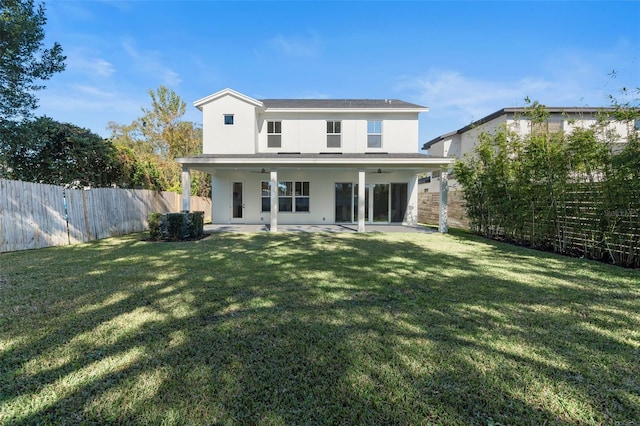 back of house featuring a patio and a lawn