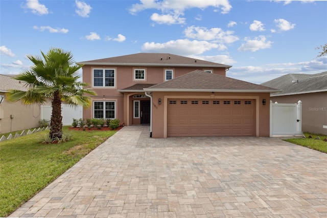 view of front of house featuring a front lawn and a garage