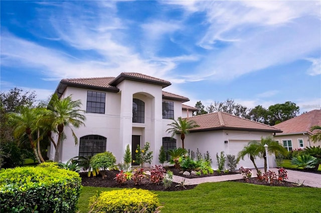 mediterranean / spanish house with a garage