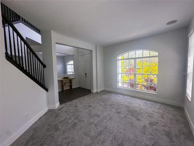 foyer entrance with dark carpet