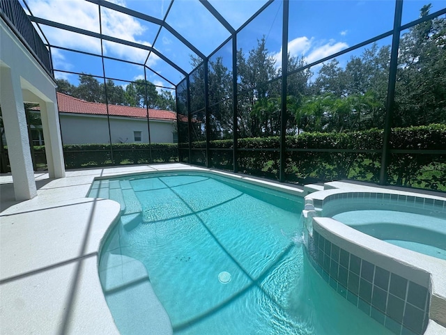 view of pool with an in ground hot tub and a lanai