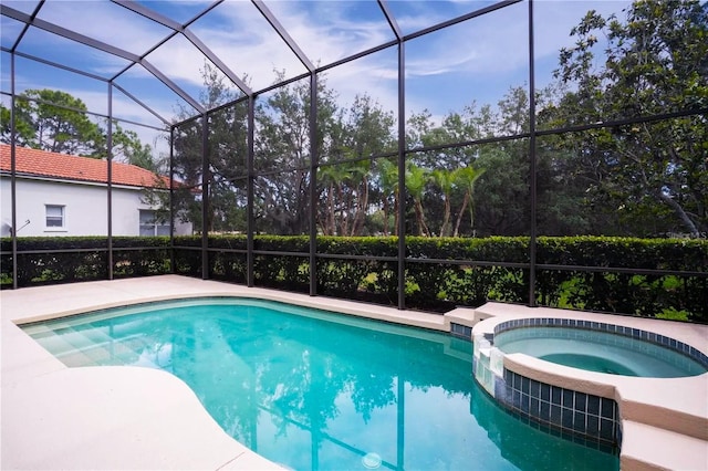 view of pool featuring an in ground hot tub and a lanai