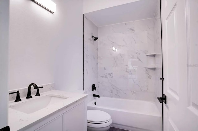 full bathroom with tiled shower / bath combo, toilet, and vanity