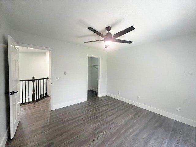 empty room with dark hardwood / wood-style floors and ceiling fan