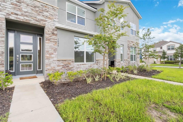 doorway to property featuring a yard