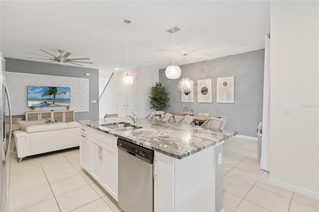 kitchen with white cabinets, dishwasher, ceiling fan, an island with sink, and sink