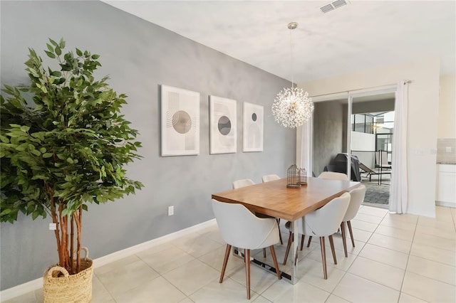 tiled dining space featuring an inviting chandelier