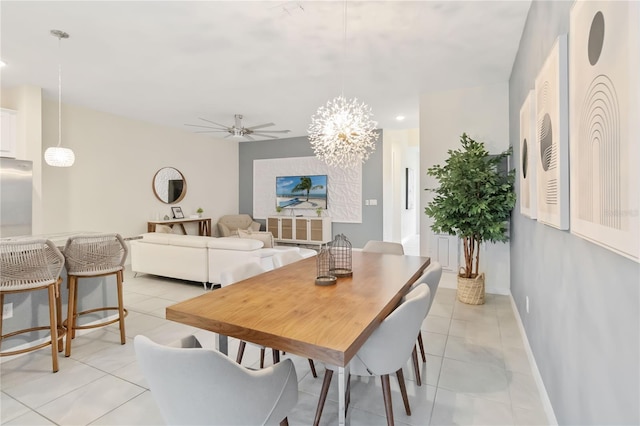 dining room with ceiling fan with notable chandelier and light tile patterned floors