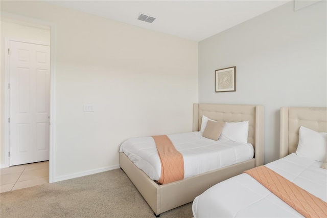 bedroom featuring light carpet