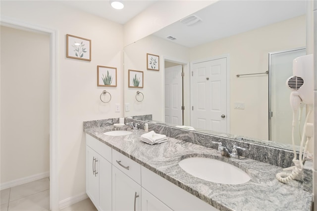 bathroom with double sink vanity and tile patterned flooring