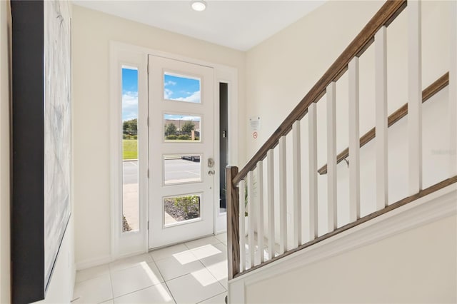 tiled foyer entrance with a healthy amount of sunlight