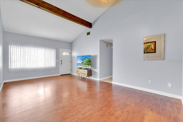 unfurnished living room featuring beamed ceiling, wood-type flooring, and high vaulted ceiling