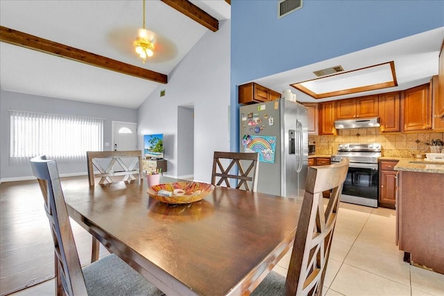 dining room with light tile patterned flooring, high vaulted ceiling, beam ceiling, and a tray ceiling