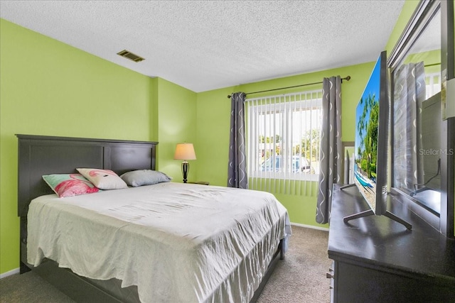 carpeted bedroom with a textured ceiling