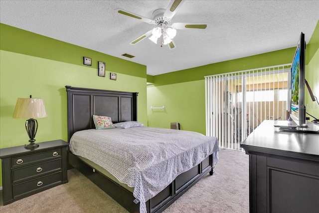 carpeted bedroom featuring ceiling fan, access to outside, and a textured ceiling