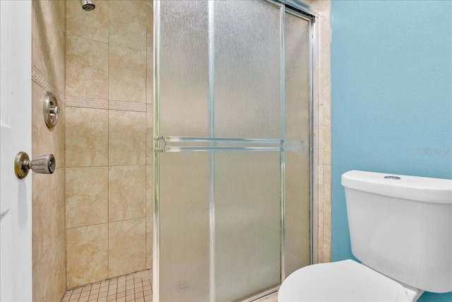 bathroom featuring toilet and walk in shower