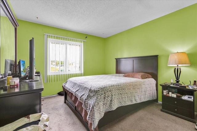 bedroom featuring light colored carpet and a textured ceiling