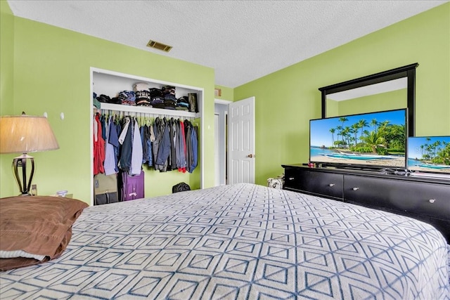 bedroom with a closet and a textured ceiling