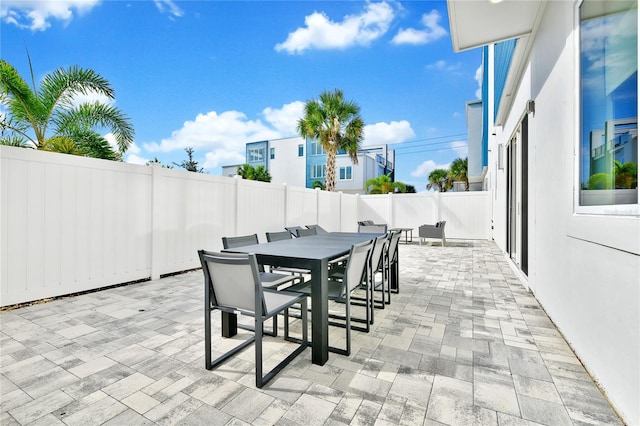 view of patio with outdoor dining space and a fenced backyard