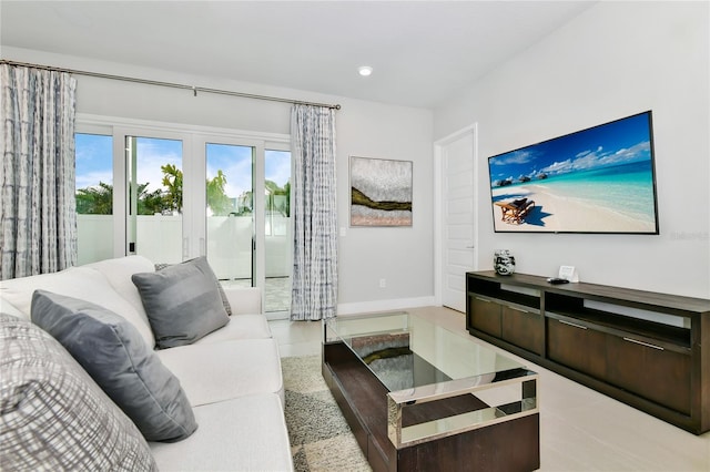 tiled living area with recessed lighting and baseboards