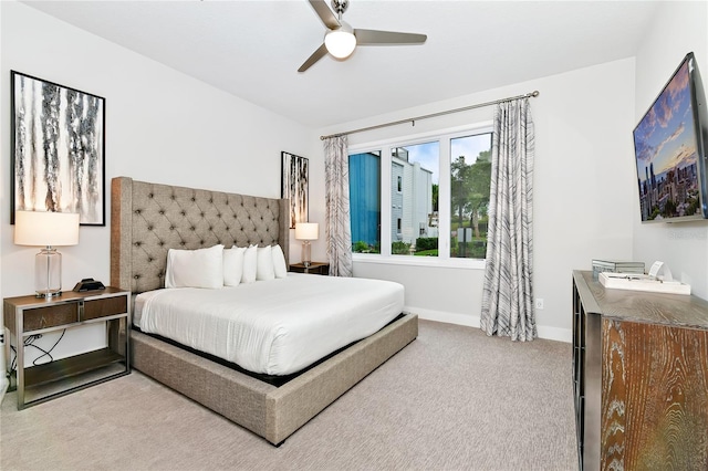 bedroom featuring ceiling fan and light carpet