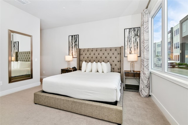 carpeted bedroom featuring multiple windows