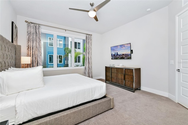 carpeted bedroom featuring baseboards and a ceiling fan