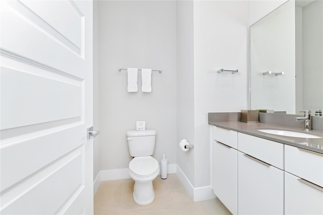 bathroom with tile patterned floors, vanity, and toilet