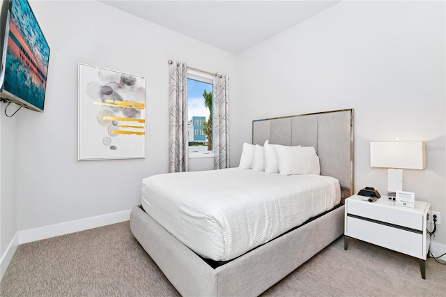 bedroom featuring light carpet