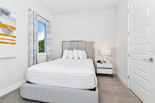 carpeted bedroom featuring baseboards