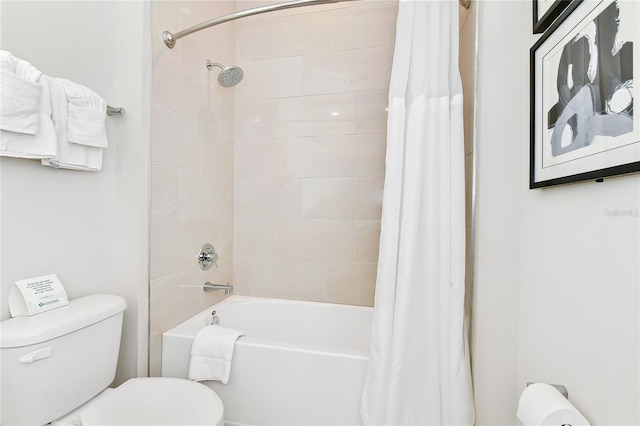 bathroom with shower / bath combo and toilet