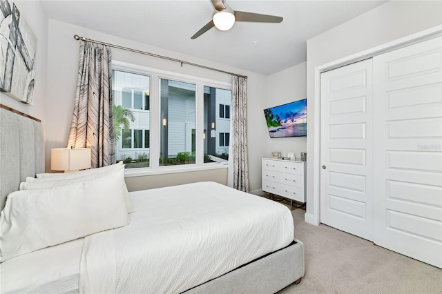 carpeted bedroom featuring a closet and ceiling fan