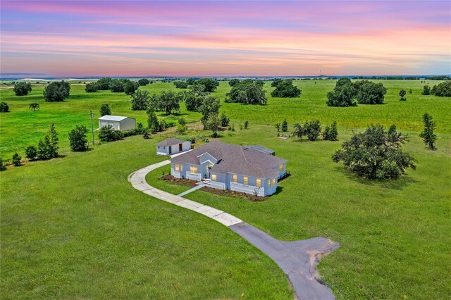 aerial view at dusk featuring a rural view