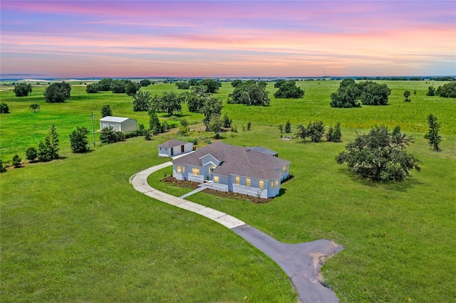 aerial view at dusk featuring a rural view