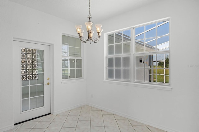 unfurnished dining area with light tile patterned floors and a chandelier