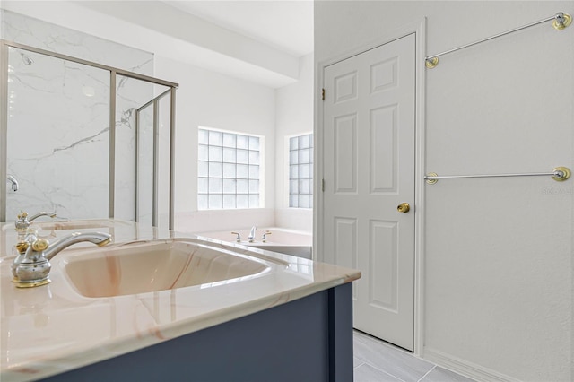 bathroom with independent shower and bath and vanity