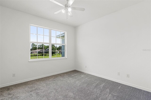 carpeted empty room featuring ceiling fan and a healthy amount of sunlight