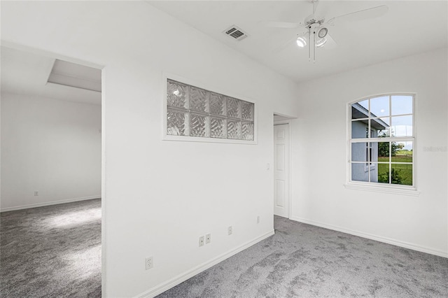 carpeted spare room with ceiling fan