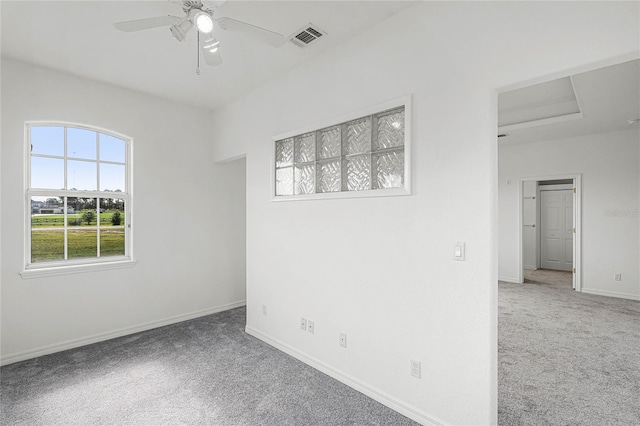 carpeted spare room featuring ceiling fan