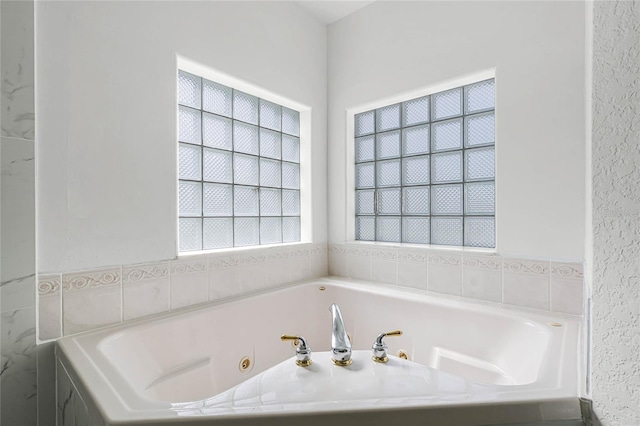 bathroom with a relaxing tiled tub