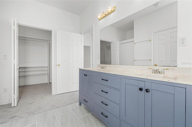 bathroom with tile patterned flooring and vanity