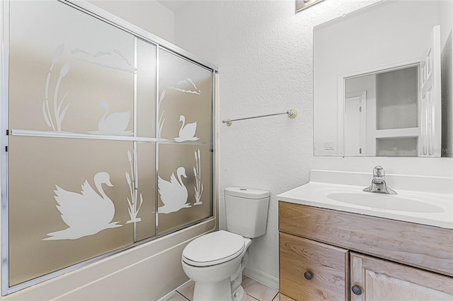 full bathroom featuring tile patterned flooring, enclosed tub / shower combo, vanity, and toilet