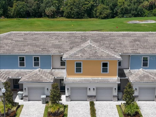 view of front of home with a garage and a front yard