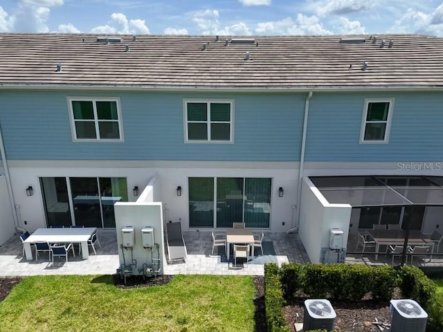 back of house with a yard and a patio area