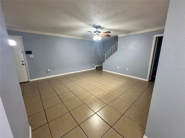 spare room with crown molding, tile patterned flooring, ceiling fan, and a textured ceiling