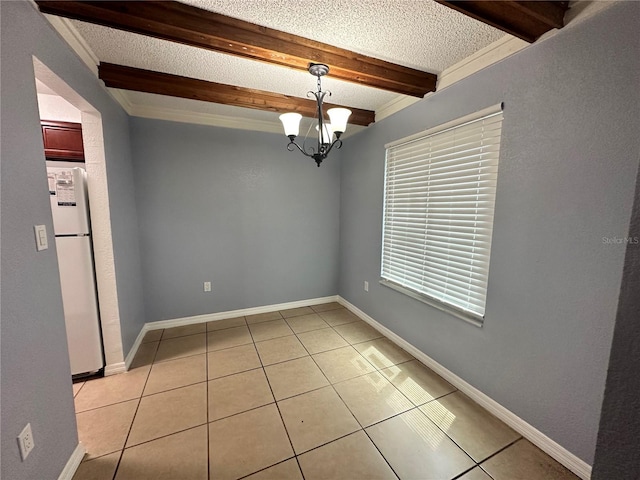 empty room featuring a textured ceiling, a notable chandelier, light tile patterned floors, and beam ceiling