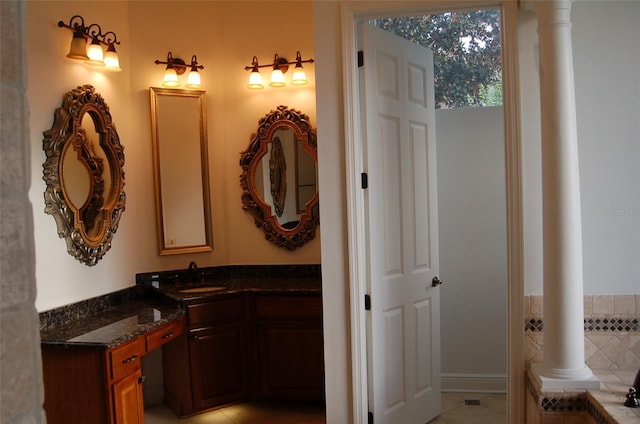 bathroom with vanity, tile patterned flooring, and a bathtub