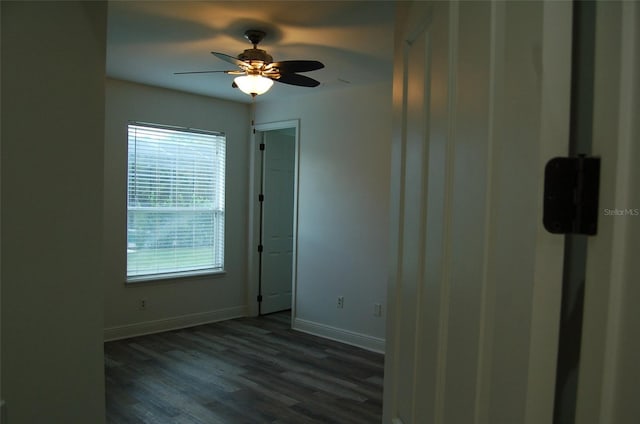 spare room featuring ceiling fan and dark hardwood / wood-style floors